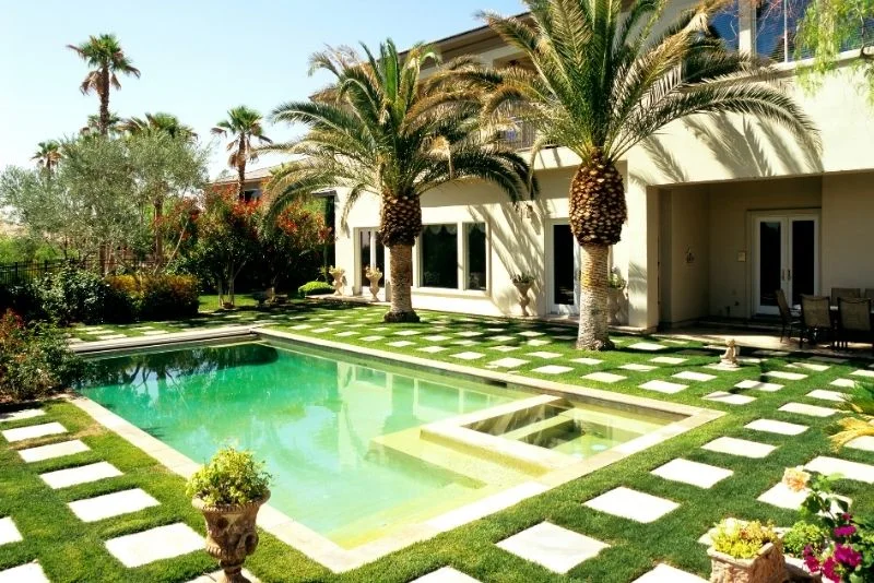 Landscaped garden surrounding a swimming pool